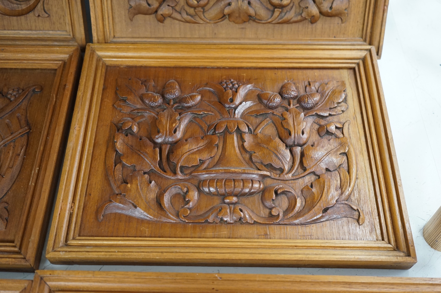 Six carved wood relief plaques, largest 31x46cm